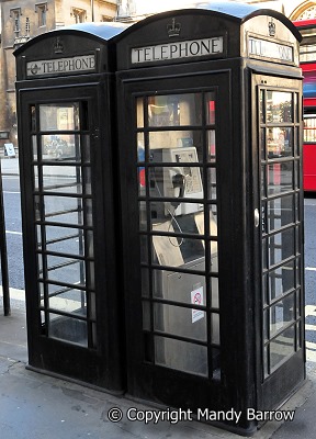 image; Black telephone boxes